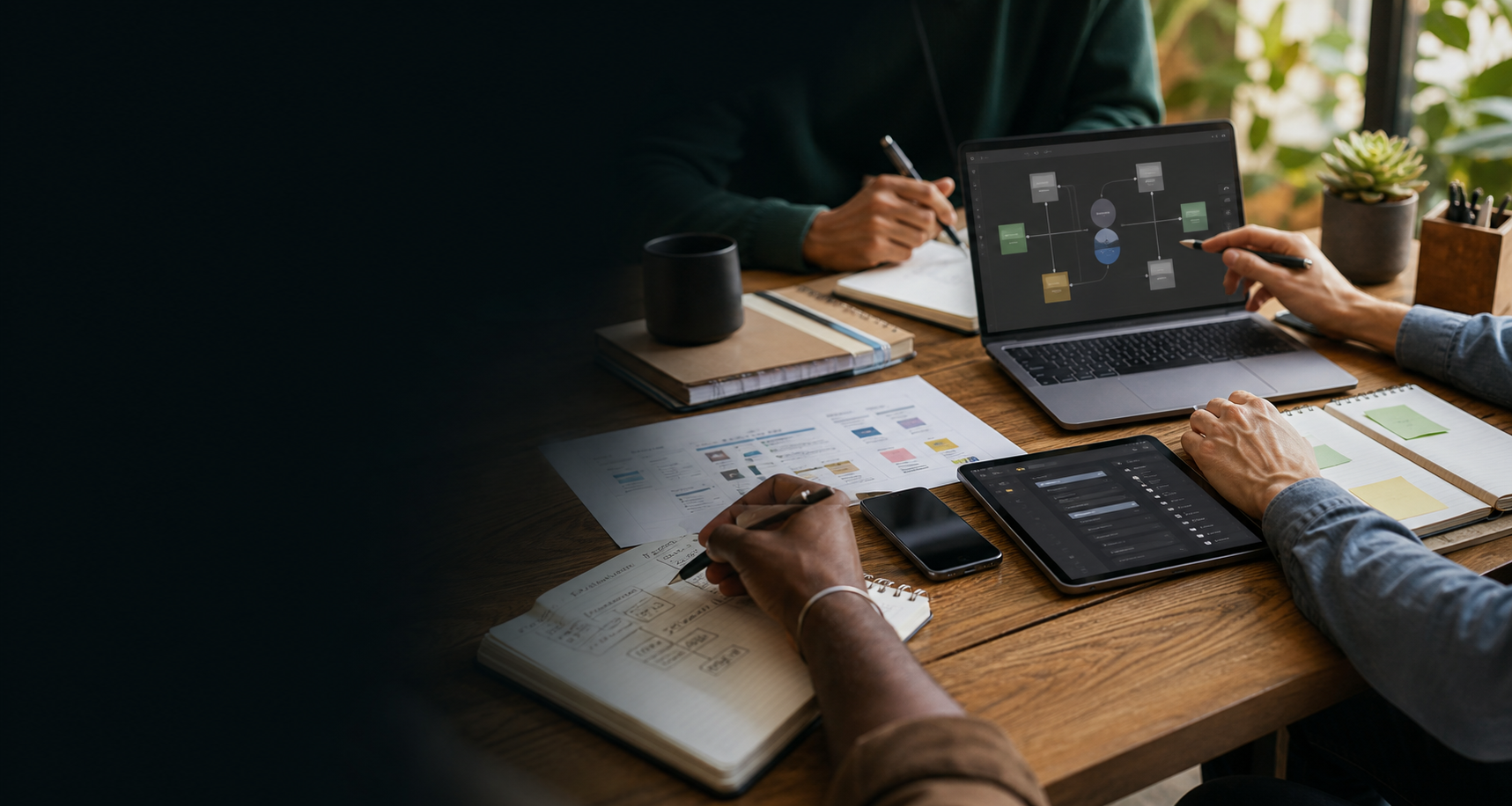 Independent workers planning digital systems with AI tools in a shared workspace.